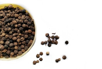 Pile of black pepper corns isolated.