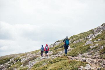 a group of tourists climb to the top of the mountain on a trip