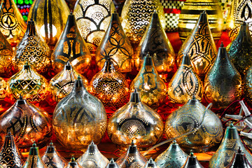 Oriental Metal crafts in Egypt. Selective focus. Gold, silver and copper lamp pieces in the Market. Background of oriental lampshades in a souk.