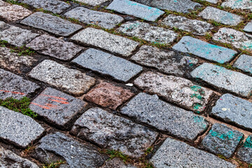 Cobblestone street texture. Regular shapes of cobblestone road, abstract background of old cobblestone pavement close-up.
