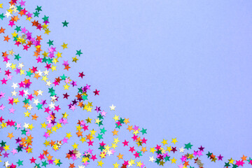 Multicolored stars on paper background in color 2022 Very Peri. Festive background. Copy-space.
