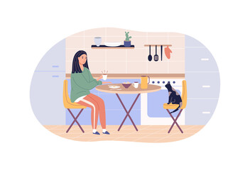 Modern woman enjoying breakfast sitting at kitchen home table. Cat seat on chair