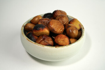 roasted chestnuts on a white background, winter