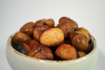 roasted chestnuts on a white background, winter