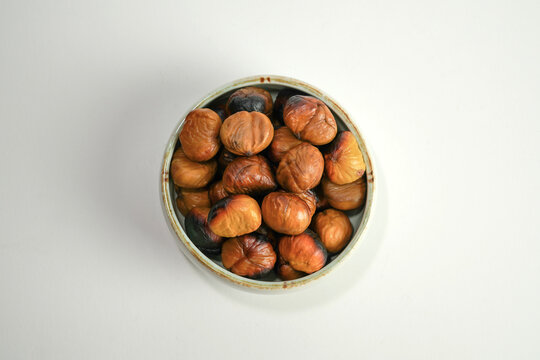 roasted chestnuts on a white background, winter