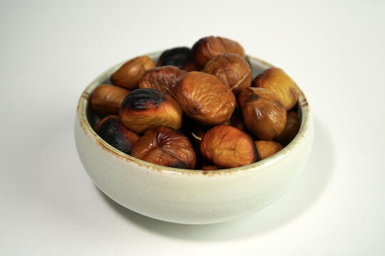 roasted chestnuts on a white background, winter
