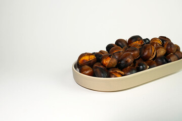 roasted chestnuts on a white background, winter