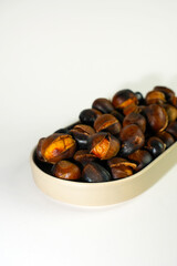 roasted chestnuts on a white background, winter