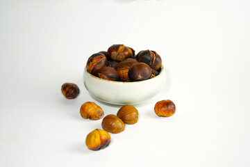 roasted chestnuts on a white background, winter