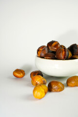 roasted chestnuts on a white background, winter