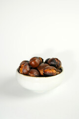 roasted chestnuts on a white background, winter
