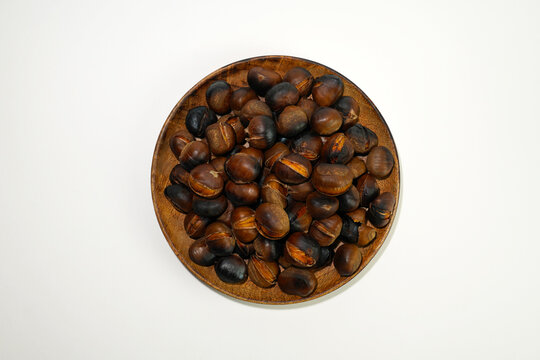roasted chestnuts on a white background, winter