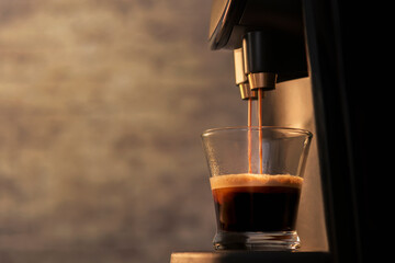 selectve focus of an espresso machine making coffee to a glass