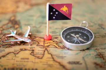 flag of Papua New Guinea, compass and airplane on the world map.