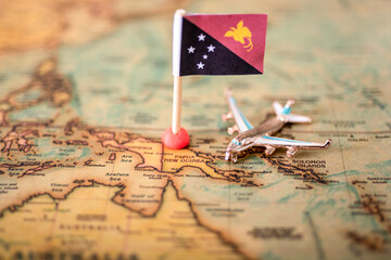 the flag of Papua New Guinea, and the plane on the world map.