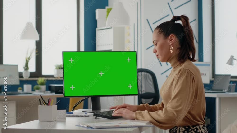 Poster employee working with green screen on computer display in startup office. monitor with chroma key ba
