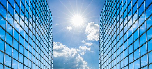 Modern office building with glass facade on a clear sky background. Transparent glass wall of...