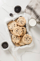 Cookies are on the marble surface with a glass of milk. - 474619859
