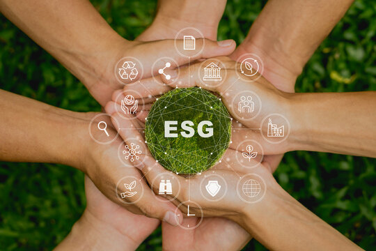 ESG icon concept in the people hand for environmental, social, and governance by using technology of renewable resources to reduce pollution and carbon emission .
