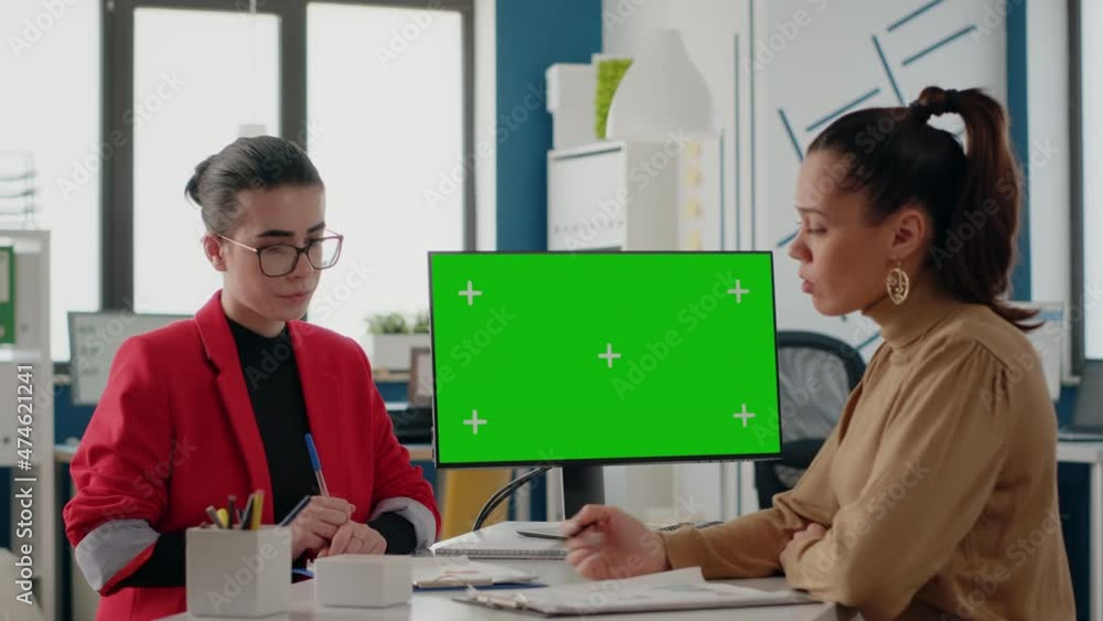 Poster women doing teamwork with isolated green screen on computer in business office. workmates using copy