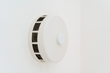 Round ventilation valve on a white wall. Fresh air in the apartment thanks to the ventilation...