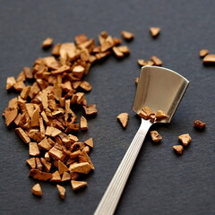 Chicory on black background. Instant coffee drink in spoon.