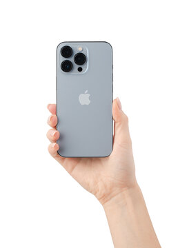 Apple iPhone 13 back side in a female hand isolated