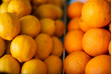 Ripe oranges are beautifully stacked on the counter.