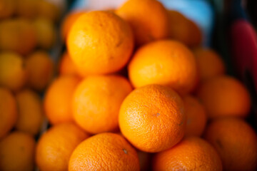 Ripe oranges are beautifully stacked on the counter.