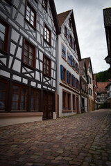 black forest houses white with red and blue and cobbled street