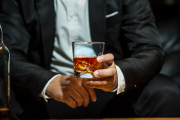Closeup businessmen holding a glass of whiskey