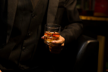 Closeup businessmen holding a glass of whiskey