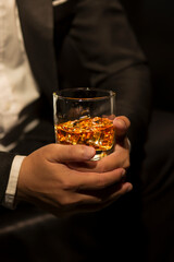 Closeup businessmen holding a glass of whiskey