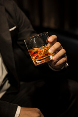 Closeup businessmen holding a glass of whiskey