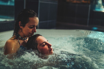 beauty relaxed woman is massaged in a whirlpool.