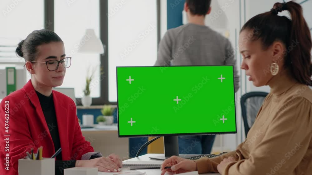 Poster coworkers working with green screen on monitor for startup business. women using isolated background