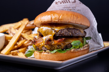 delicious black angus beef double cheese burger with fries