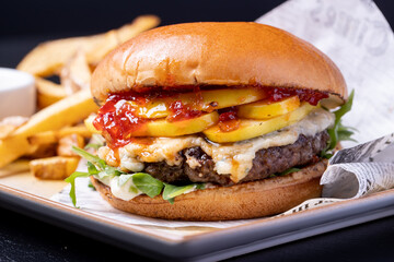 details of tasty black angus beef burger with gorgonzola