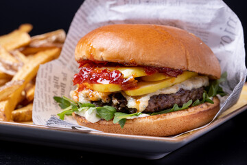 details of tasty black angus beef burger with gorgonzola
