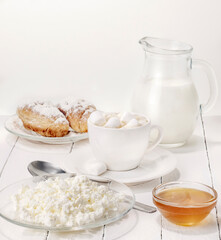 breakfast coffee with milk and marshmallows, croissants with honey and cottage cheese