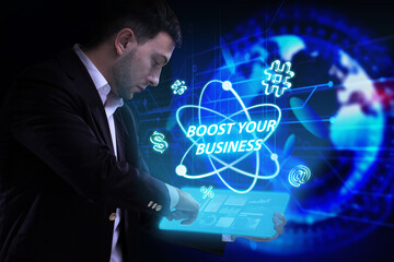 Business, Technology, Internet and network concept. Young businessman working on a virtual screen of the future and sees the inscription: Boost your business