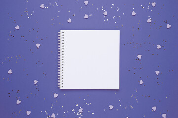 White empty sheet in notebook on background with hearts. Copy space. Place to your text. Valentine's, women's day, love concept. Top view. Trendy color of the year 2022. Very peri