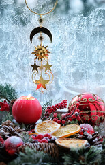 altar for Yule. golden amulet, Wiccan Solstice symbol and red candle, winter festive decor on...