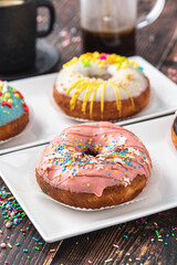 Delicious donuts decorated with different decorations on wooden table