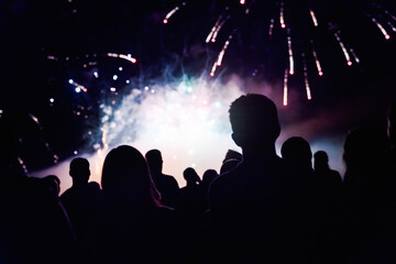 Fototapeta na wymiar Crowd watching fireworks and celebrating new year eve