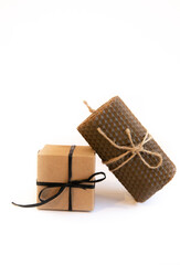 Craft Hand made Gift Box with black Ribbon Bow on White Background and Brown Wax Candle Present on Holiday Monochrome Gift Wrap Packing Man's Present Close-up Copy space Vintage