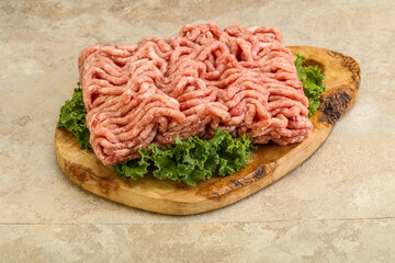 Raw pork minced meat over board