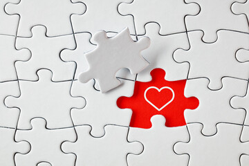 A heart shape on missing puzzle piece. To find love