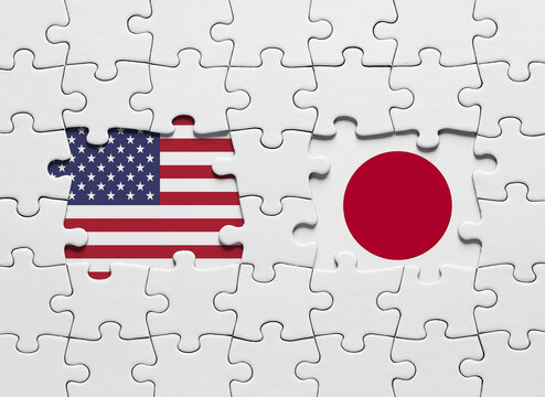Puzzle with the national flags of United States of America and Japan - Powered by Adobe