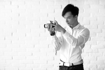 Asian man with a camera black and white
